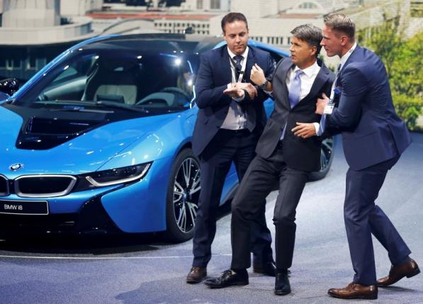 BMW CEO Krueger is helped after he collapsed at a presentation during the media day at the Frankfurt Motor Show (IAA) in Frankfurt